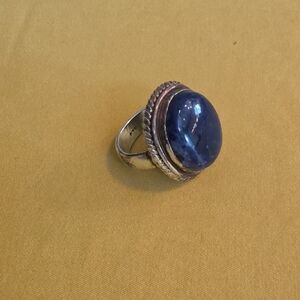 Vintage-style sterling silver ring featuring a large, oval blue kyanite cabochon